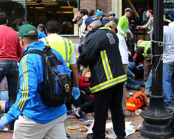 BOSTON - APRIL 15: Emergency personnel respond to the scene of the first explosion on Boylston Street near the finish line of the 117th Boston Marathon, April 15, 2013. (Photo by John Tlumacki/The Boston Globe via Getty Images)
